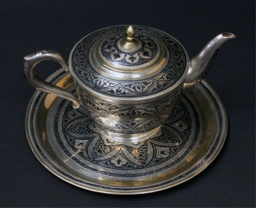 Russian Niello Gilt Teapot and Tray: Est. $ 500-750 Russian Niello Gilt Teapot and Tray Measures 4 inches tall. Tray is 7 inches across. Weighs 13.955 ozt. Stamped 7KXK, Star with Hammer and sickle, and 875.
