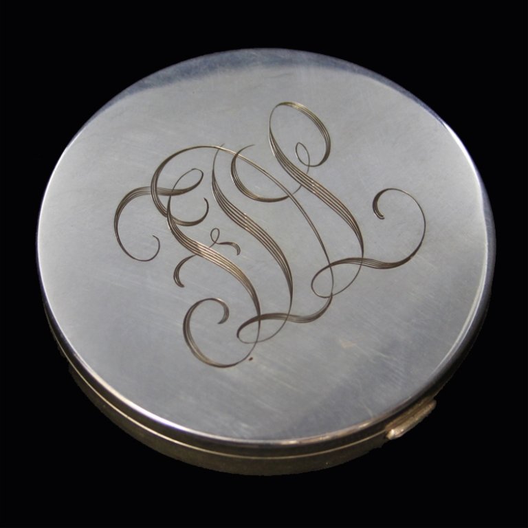 Sterling Tiffany & Co Compact: Est. $ 100 - 150 Sterling Tiffany & Co Compact Monogrammed FDL and marked sterling, has a mirror and loose powder with applicator. Comes with original cloth bag that says Tiffany & Co. 3" diameter and