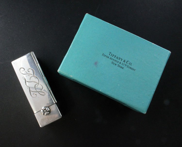 Vintage Tiffanys & Co Silver Lipstick Compact: Est. $ 80-120 Vintage Silver Lipstick Compact with Mirror from Tiffany & Co. Marked Tiffany & Co with a TC mark above it, monogrammed FDL, weighs 2.18 Troy oz, has some wear and comes with original bo