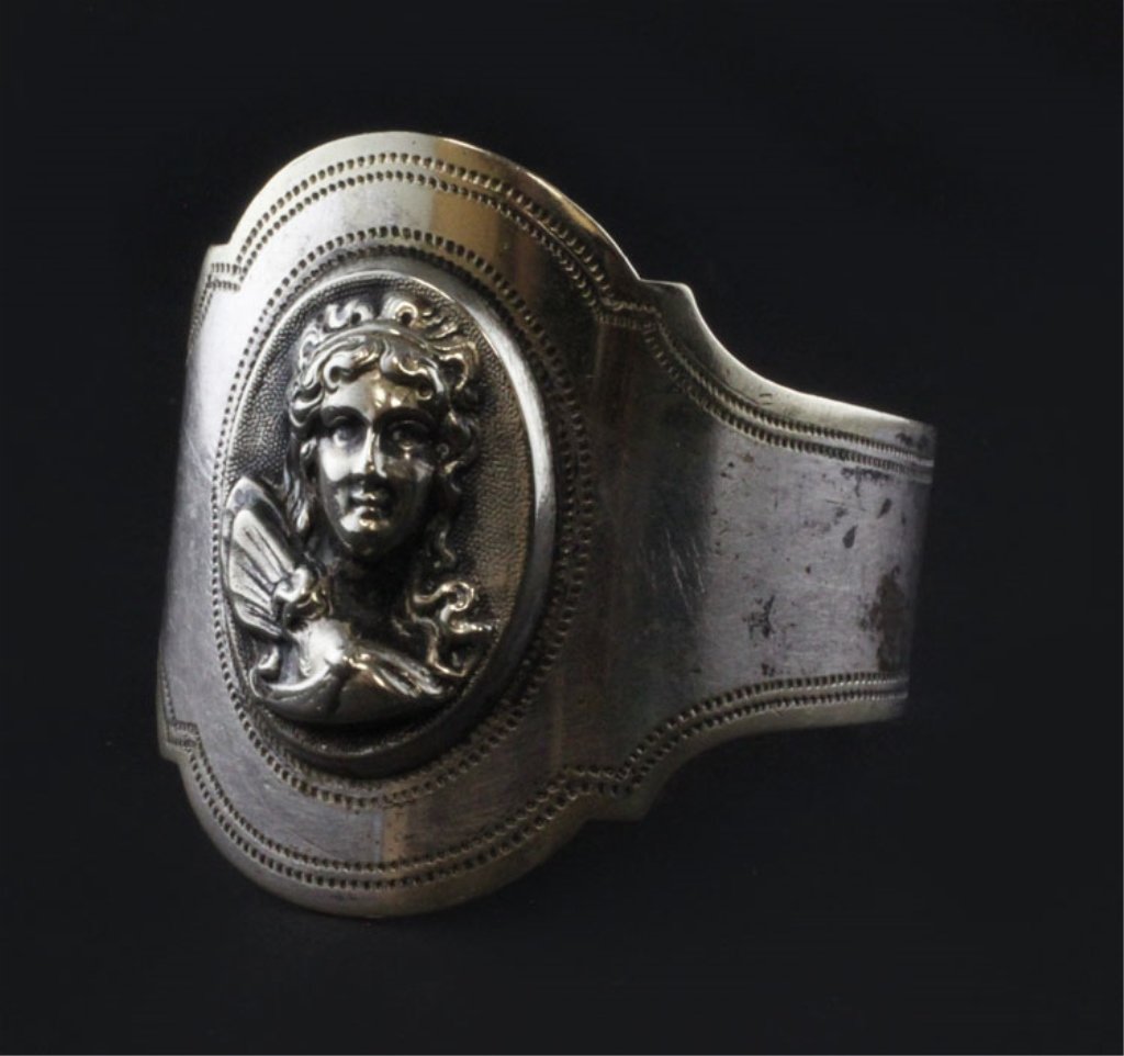 Oval Medallion Napkin Ring: Est. $ 30 - 50 Oval Medallion Napkin Ring No marks observed likely sterling, engraved Maggie E Austin, relief women's torso, late 19th century. 1 3/4" in diameter x 1 5/8" wide and weighs .53 ozt