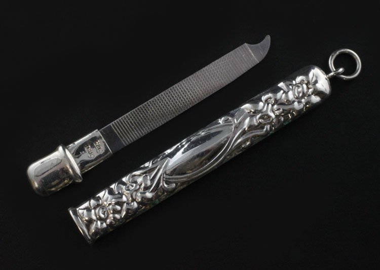Sterling Nail File and Case: Est. $ 15-25 Sterling Nail File and Case Marked 925 and REO, 3" long with a floral design, weighs .27 troy oz