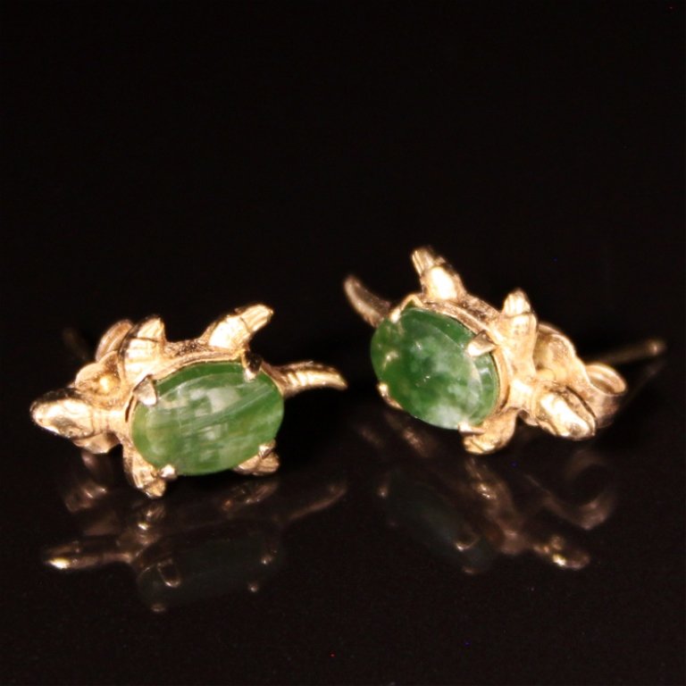 Jade Earrings Turtle Design in Yellow Gold: Est. $ 75-125 Jade Earrings Turtle Design in Yellow Gold 1.24 grams 14kyg. Turtle shell is jade. Green in oval cabachon. 6.9 X 5.1mm. Turtle is 1/2 X 1/4".