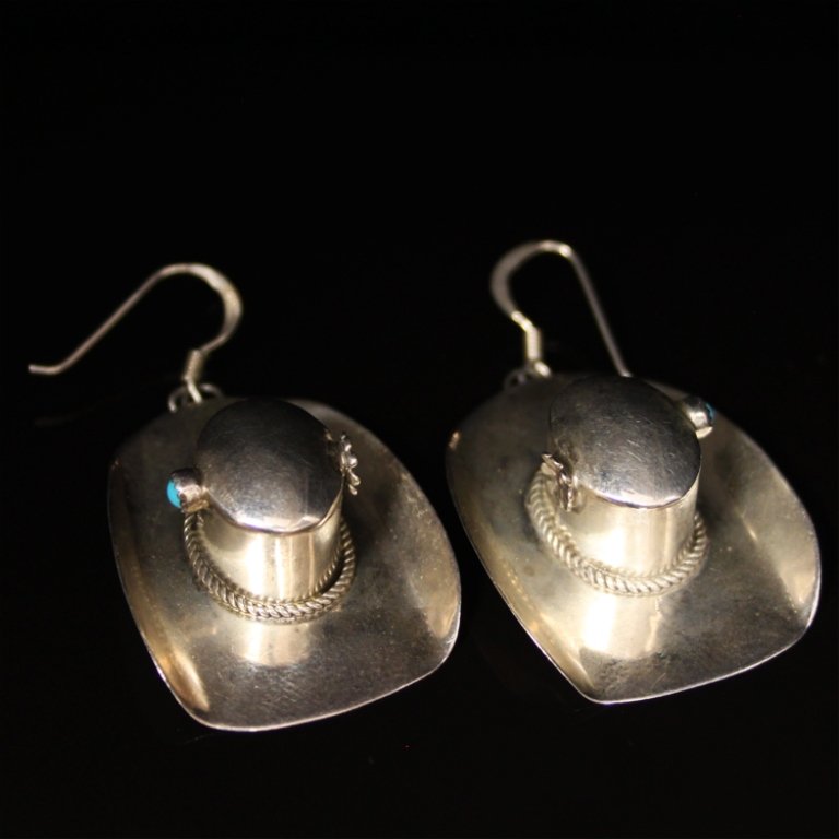 Native American Made Cowboy Hat Earrings: Est. $ 125-250 Native American Made Cowboy Hat Earrings In sterling 8.68 grams. Maker marks "KS". Gemstone accents: (2) turquoise 2.50mm round cabachon. 2 X 1 " overall dimensions. Great looking set.
