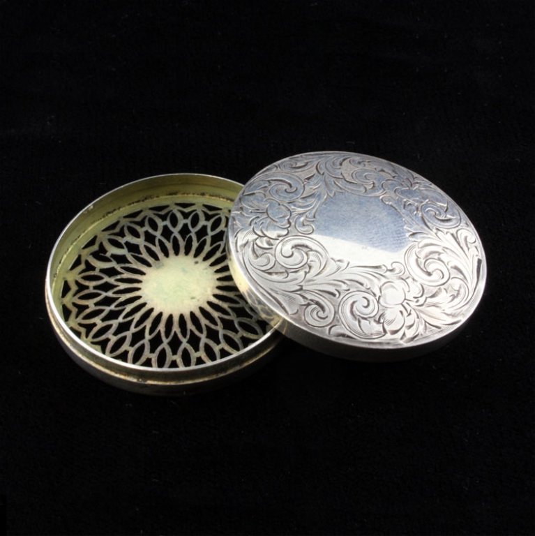 Sterling Sheffield Pill Box: Est. $ 30 - 60 Sterling Sheffield Pill Box. The lid is decorated with floral and foliage repousse, the bottom has an open geometric pattern and the inside is vermeil. Marked with the Sheffield makers 