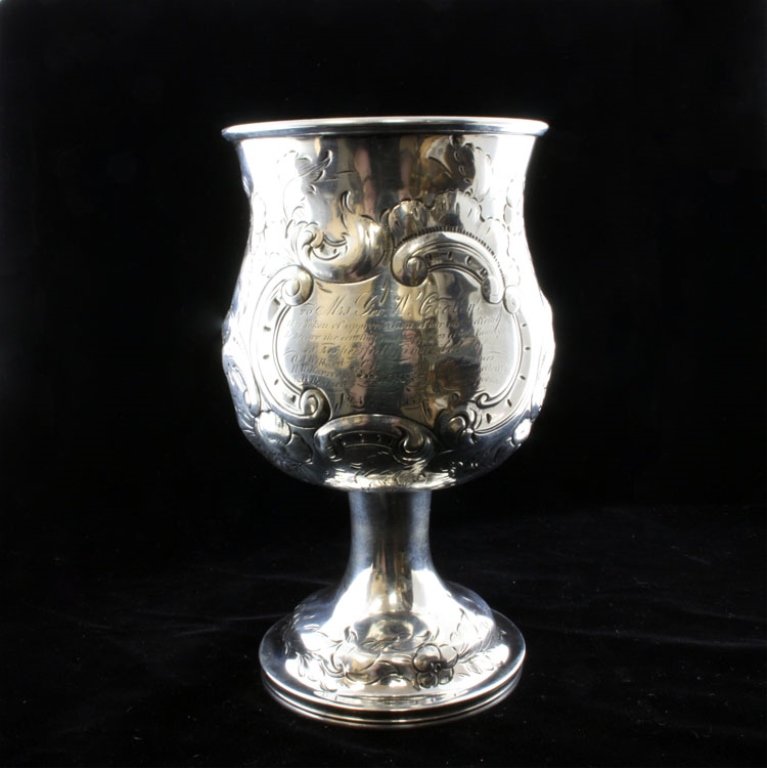 Silver Presentation Goblet: Est. $ 130 - 160 Silver Presentation Goblet. Repousse and engraved goblet marked Jan 1854, no observed marks or makers mark, 9" tall x 3 1/2" wide and weighs 5.68 ozt