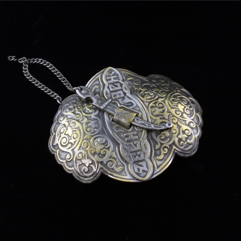 Slote & Schaffer Belt Buckle: Est $ 60-125 Vintage Russian styled Niello vermeil silver 2 piece buckle that is held together with a dagger on a chain. This is marked Slote & Schaffer, New York and Sterling. The belt buckle is 3" l