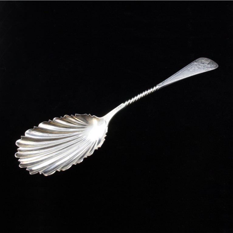 C.F. Rudolph Silver Serving Spoon: Est $ 45-75 Silver spoon with a shell shaped bowl with a spiral twisted handle terminating into a bright etched pattern surrounding a monogrammed B. The reverse of the handle is marked C.P. Rudolph an