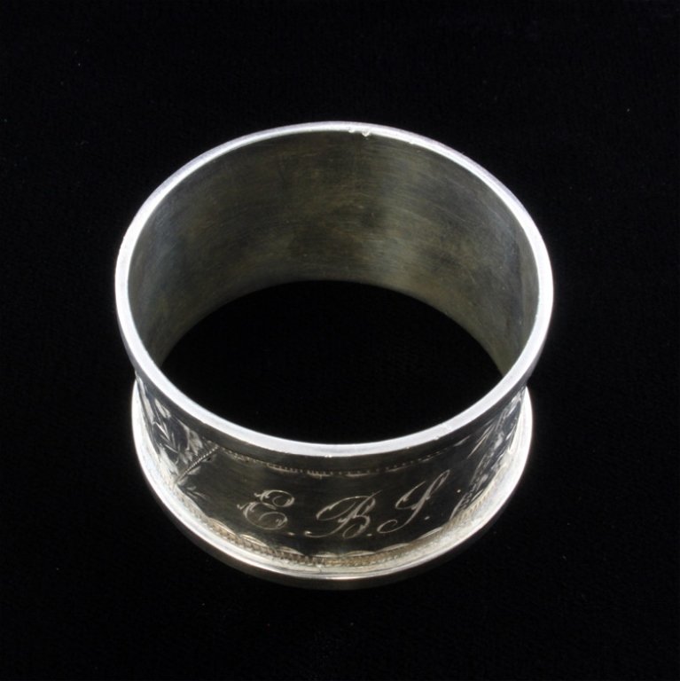 Patterson & Sons Ltd Napkin Ring: Est. $ 20-45 Patterson & Sons Limited Sterling napkin ring bears the Birmingham, Patterson & Sons marks with the M date mark for 1911. Bright etch cut geometric and floral design with a personal monog