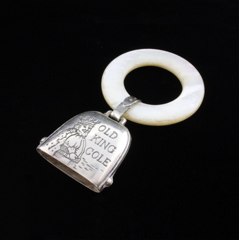 MOP & Sterling Teething Ring/ Rattle: Est. $ 20-45 Sterling Rattle/Bell Etched with Old King Cole and marked sterling on the reverse. The teething ring is mother of pearl that is 1 1/2" in diameter, the ring has a crack. The ring designed