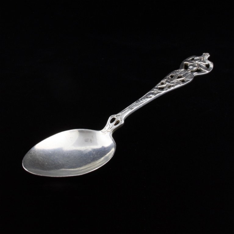 Watson Sterling Spoon: Est $ 20-60 On the reverse of the handle is the Watson crown, W, Lion makers marks beside the impressed mark "Sterling". On the reverse of the bowl has 1911 engraved, the handle is a pierced and flora