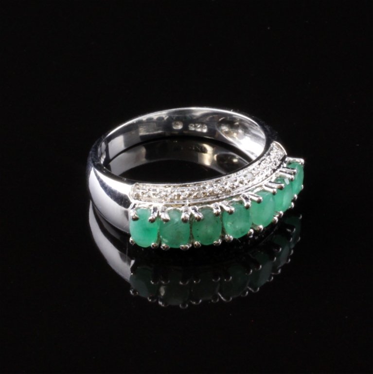 Ladies Emerald & Diamond Ring in Sterling: Est. $ 100 - 175. Ladies Emerald & Diamond Ring in Sterling. 3.18gr. Emeralds: (7) 4.0 X 3.0mm approx. oval faceted natural. Heavy inclusions. Diamonds: (4) .002ct each approx. Single cut. Marked .925
