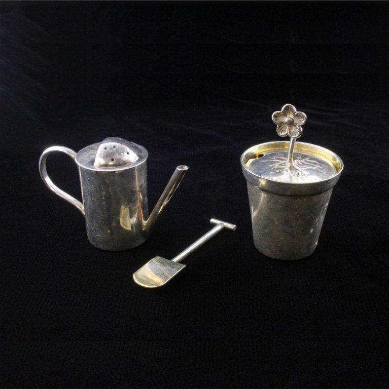 Tiffany & Co Open Salt Cellar and Pepper Shaker: Est $ 60-95 Tiffany & Co Set from Firenze (Florence) Italy has a Sterling Open Salt Cellar in the shape of a flower pot with a flower protruding from the center of the lid that acts as a grip to open 