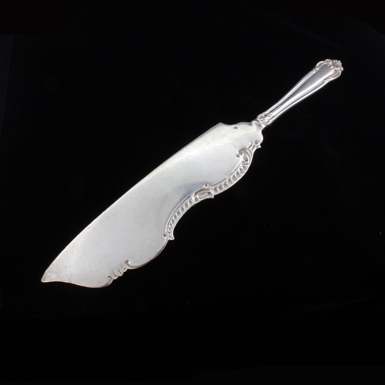 Frank W. Smith Silver Co. Inc. Cake Knife: Est $ 95-140 Cake knife made by and marked for Frank W. Smith Silver Co. Inc. The knife's handle has a ornamented relief border and the blade has a repousse top edge, it measures 10 1/4" long x 1 3/4"