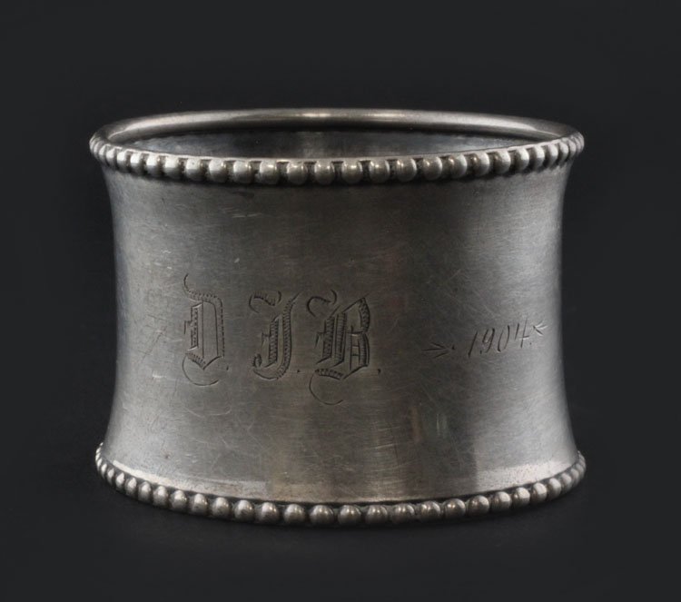Sterling Napkin Ring Holder: Est. $ 15-30 Sterling Napkin Ring Holder Monogrammed DJB, and 1904, marked sterling, the diameter is 1 1/2". Weighs .47 troy oz, and has a beaded border.