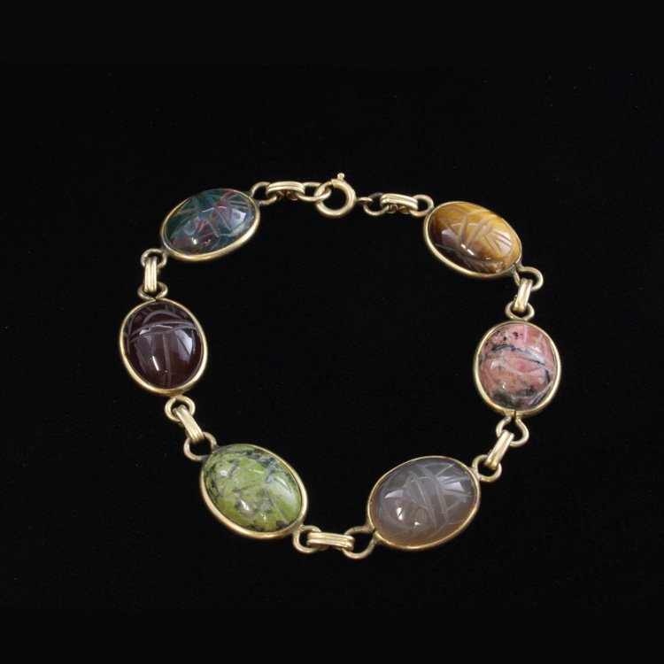 Vintage Gemstone Scarab Beetle Bracelet: Est. $ 50 - 100 Vintage Gemstone Scarab Beetle Bracelet. Yellow gold filled. Gemstones include carnelian, chrysaberl, rhodonite and more. Stones are 11.70 X 15.40mm. 7 3/4" long.