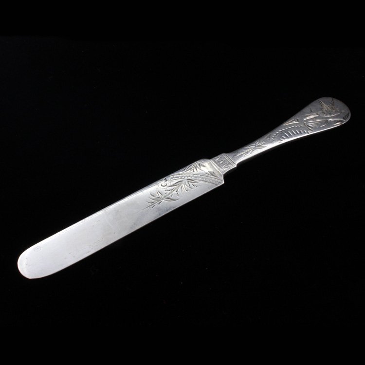 N.G. Wood & Son Butter Knife: Est $ 100-140 Sterling butter knife made by N.G. Wood and Son with a bright cut etched bird, floral and geometric pattern. The reverse of the handle is marked sterling and N.G. Wood & Son. The knife m