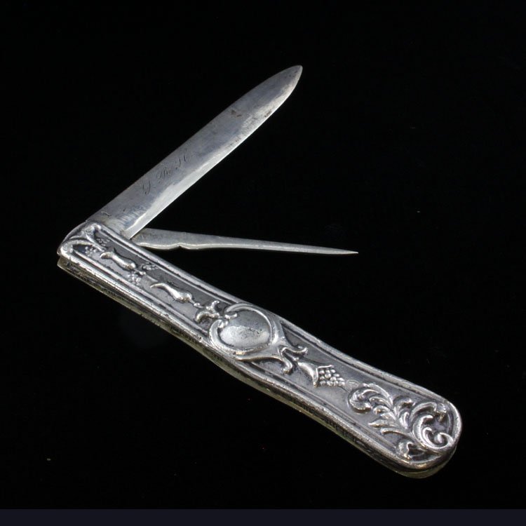 Coin Silver Pocket Knife/ Fruit Knife: Est $ 80-130 Pocket knife/ fruit knife with a low relief fruit and scroll work pattern with a blade and fruit pick. The blade is marked coin and is monogrammed with what appears to be L. RYC. The knif