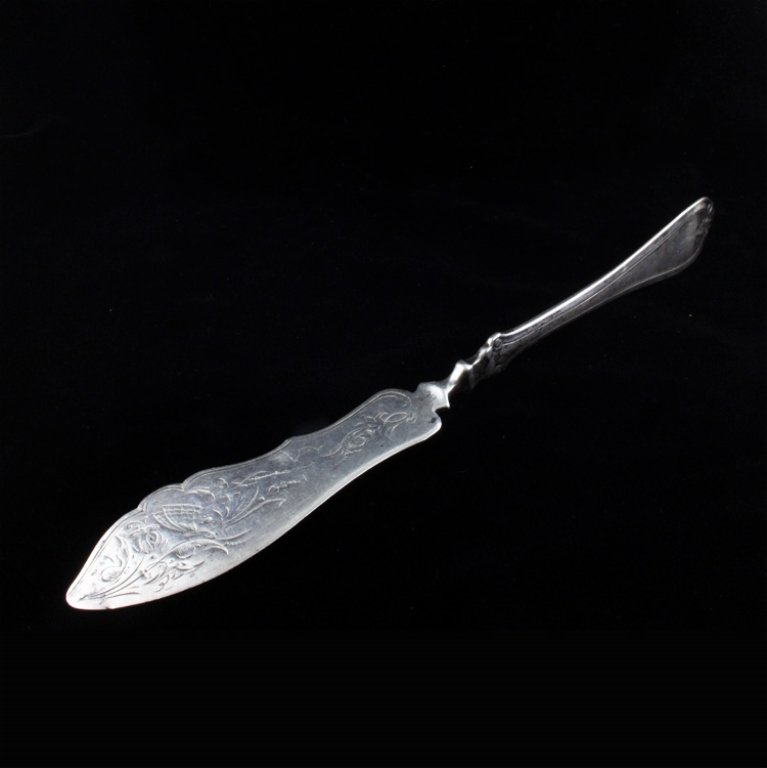 J.E. Caldwell Sterling Master Butter Knife: Est $ 70-130 Sterling master butter knife made by J.E. Caldwell with a low relief scroll design on the handle that resembles the Gorham Raphael pattern. The knife is marked J.E. Caldwell and measures 