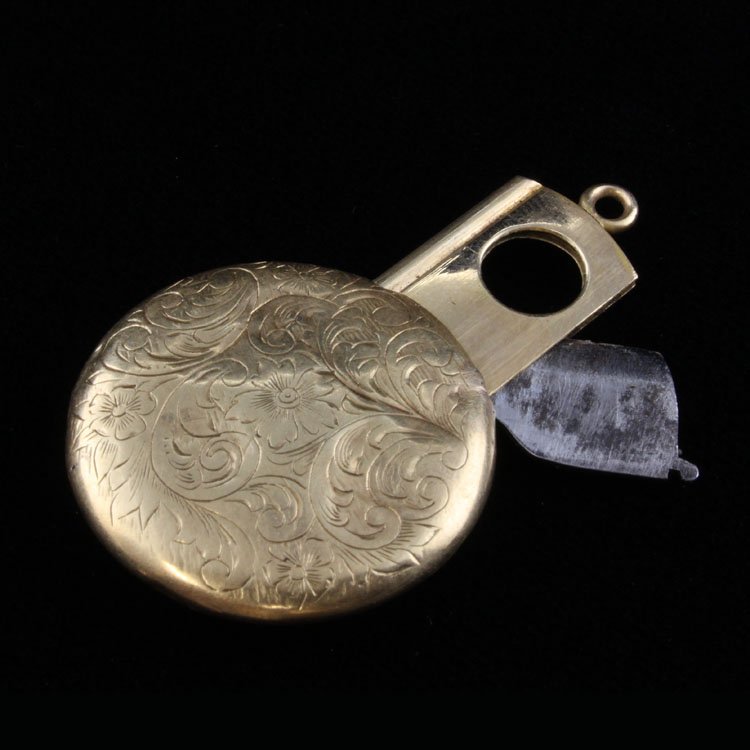Vintage 14k Hidden Cigar Cutter Pendant: Est. $ 200 - 300 Vintage 14k Hidden Cigar Cutter Pendant 14k yellow gold. 7.23 gr. Round engraved case with retracable cigar cutter. Case has condition issues that includes some dents in the surface. 