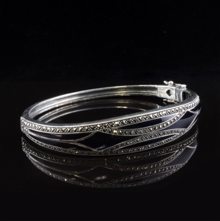 Ari D. Norman London Blue Enamel Bracelet in Sterl: Est. $ 125 - 175 Ari D. Norman London Blue Enamel Bracelet in Sterling 22.53 grams. Designed with inlaid blue enamel. Accenter with Marcasite gems. Bracelet is 1/2" at widest point. Good condition.