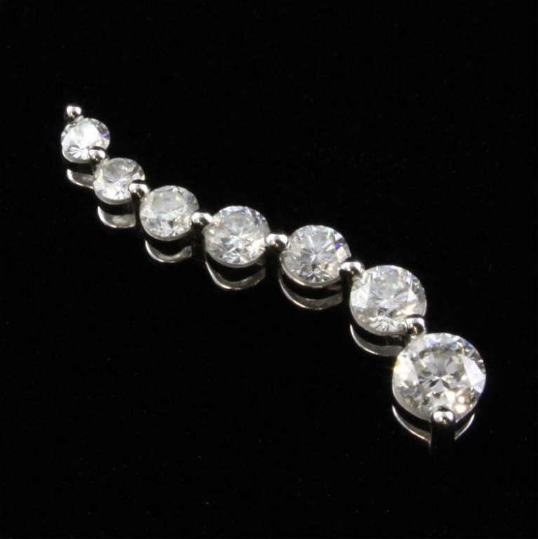 1.00 Ct tw Diamond Journey Pendant: Est. $ 500 - 750 1.00 Ct tw Diamond Journey Pendant 14k White gold. 1.29 gr tw. Diamonds (7) 1.0 ct tw round brilliant. Si-I Near colorless. 1" long. Marks: 14k and ZEI