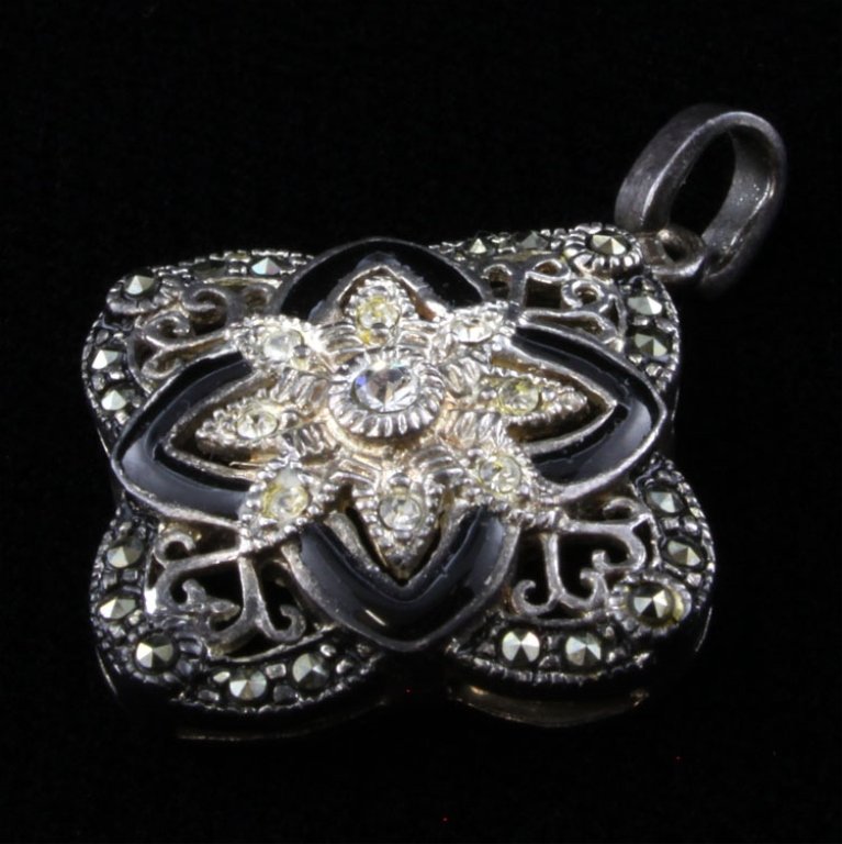 Sterling Quatrefoil Pendant: Est. $ 30 - 50 Sterling Quatrefoil Pendant 4.18 grams. Barbed Quatrefoil design with Marcasite, enamel and rhinestone accents. 7/8 X 1 1/8'.