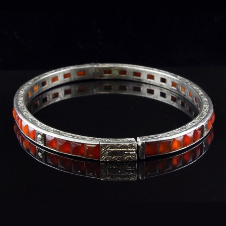 Vintage Carnelian & Marcaise Bracelet in Sterling: Est. $ 50 - 100 Vintage Carnelian & Marcaise Bracelet in Sterling 13.56 gr. Gemstone & Carnelian square polished channel set with marcaise accents. Band is 4.90mm wide. Marks- sterling.