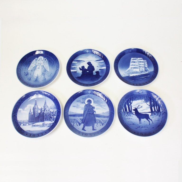 Set of 6 Royal Copenhagen Plates: Est $ 200-300 Royal Copenhagen, Hans H. Hansen blue and white plates. The dates on the plates include: 1953, 1957, 1958, 1959, 1960 and 1961. The reverse of the plates bear a wire attachment loop, and