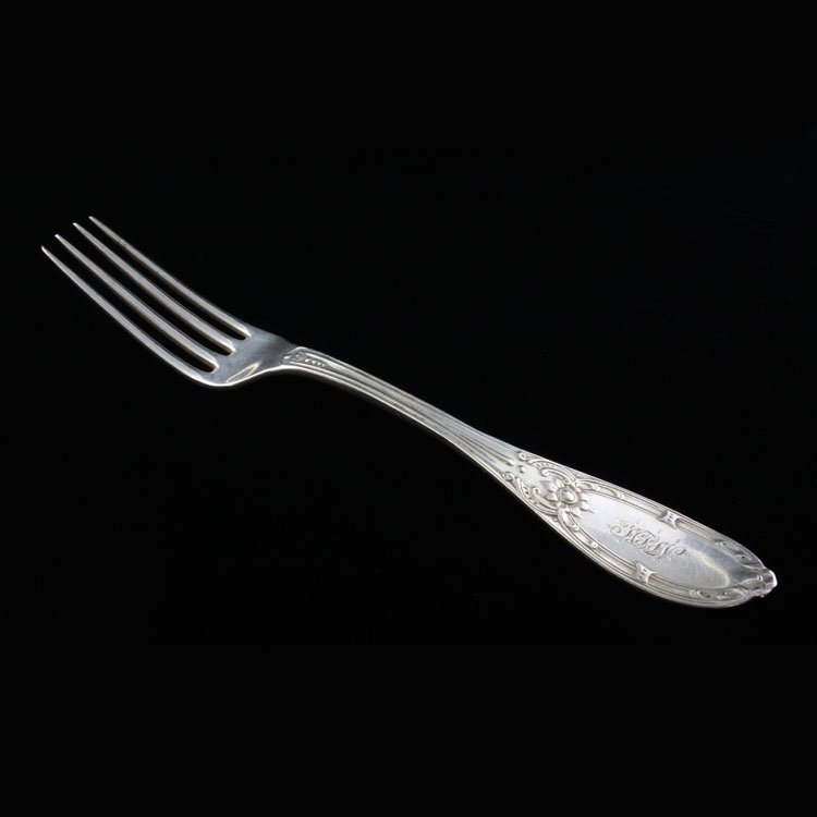 Sterling Albert Coles Jenny Lind Fork: Est $ 100-160 Sterling fork made by Albert Coles with the1850 Jenny Lind pattern. The handle is engraved H.L.W and the reverse of the handle bears the worn Albert Coles makers marks. The fork measures