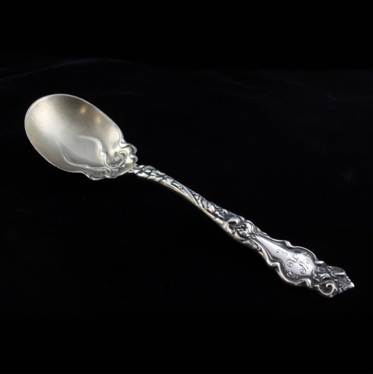Wallace Silversmiths Eton Sugar Spoon: Est $ 60-130 Sterling sugar spoon made by Wallace Silversmiths with the1903 Eton pattern. The handle is monogrammed with a decorative letter K, the reverse of the handle is marked Wallace, Sterling an