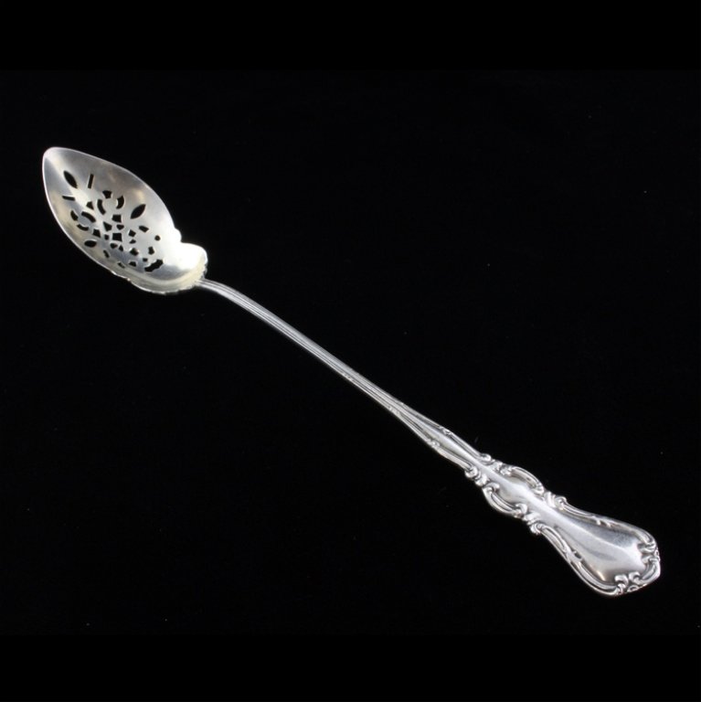 Sterling Olive Spoon: Est $ 80-140 Sterling olive spoon with a reticulated bowl and a scrolled border pattern that has an unreadble maker mark. The reverse of the handle is marked sterling, fine and 925. The spoon measures