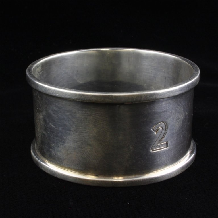 William Neale Sterling Napkin Ring: Est $ 80-140 Sterling napkin ring from Chester, England made by William Neale. The napkin ring bears the maker marks and is etched with a number 2. The ring measures 1 7/8" in diameter x 1" high and w