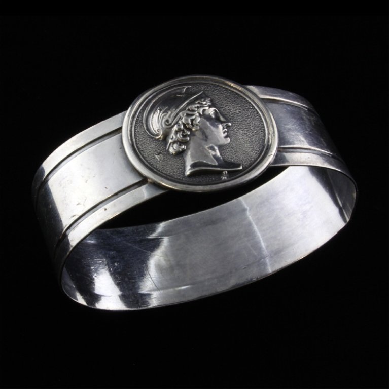 Silver Medallion Napkin Ring: Est $ 40-80 Silver napkin ring ornamented with the medallion of a roman soilders bust. The ring is engraved Alice and has two chased borders. The ring measures 2 1/8" long x 1 1/2" wide x 1" tall and 