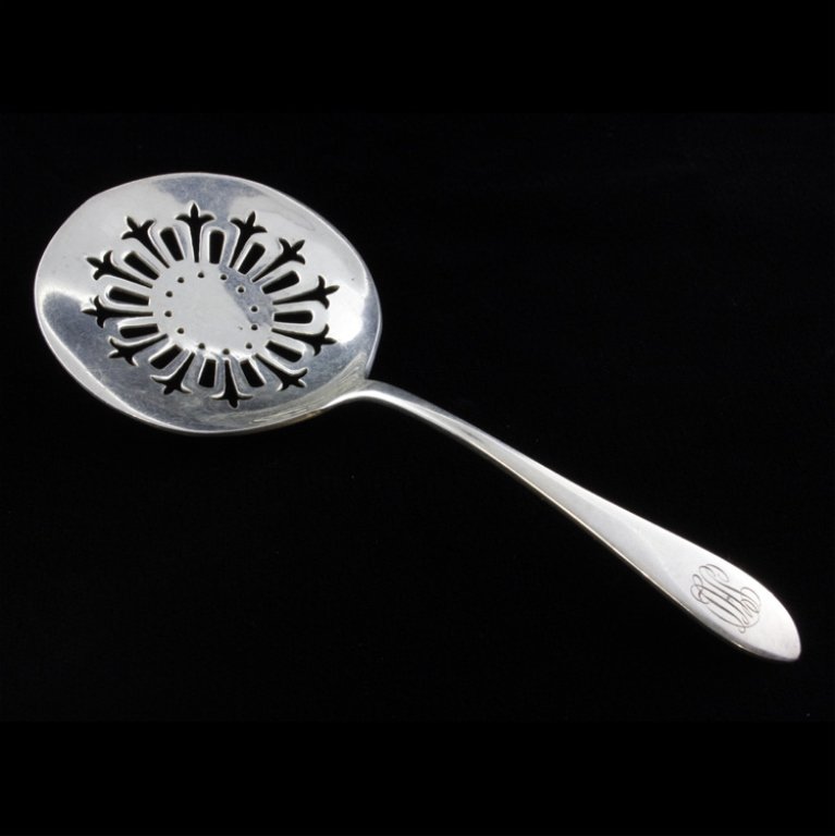 Wallace Sterling Bon Bon Spoon: Est $ 60-120 Sterling bon bon spoon made by Wallace Silversmiths with a pierced bowl. The handle is monogrammed LHL and the reverse is marked sterling. The bon bon measures 5" long x 2" at the widest