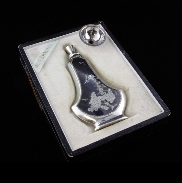 Japanese Sterling Bottle w/ Funnel & Fitted Box: Est $ 100-200 Japanese sterling perfume bottle with a bright cut etched scenic design including a cherry blossom tree and a mountain amoung a dark background. The perfume bottle comes with a funnel a 