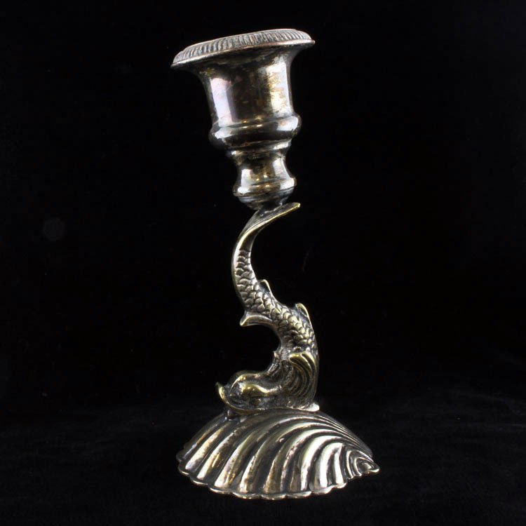 E.P.N.S Koi Fish/ Dolphin Candlestick Holder: Est $ 50-90 Silverplated candlestick holder with a shell figural bass that transitions into a koi fish/ possibly a dolphin and terminates into a candstick holder. It bears slight discoloration and is 