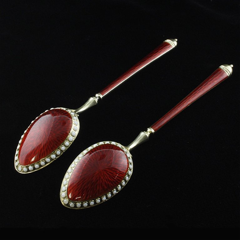 David Anderson Enamel & Sterling Demitasse Spoons: Est $ 60-120 Set of two vermeil, sterling and enamel ornamented demitasse spoons made by David-Andersen. The reverse of the bowl is decorated with a enamel gullioche oval encircled by a white enamel b