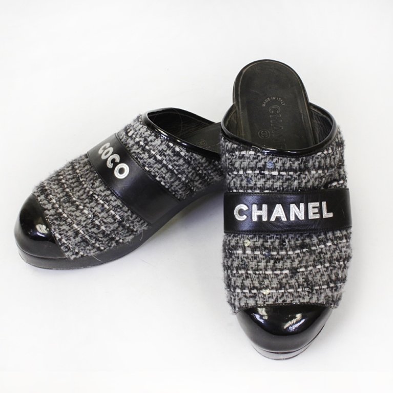 Chanel Tweed Slip on Clogs: Est. $ 100 - 200 Tweed grey and black clogs with sequins and has Chanel written over the toes. Made in Italy by Chanel.Size ten 10 1/2" long x 3 1/2" wide and a 2" tall heel.