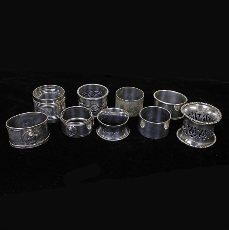 Set of 9 Miscellaneous Silver Napkin Rings: Est $ 80-160 Set of 9 miscellaneous silver napkin rings. One marked Gorham and a few are engraved or bear etched designs. Two of the napkin rings have medallions and are possibly coin silver. The lot 
