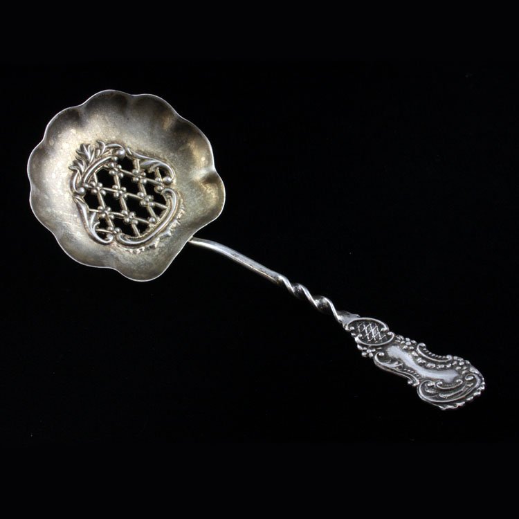 Sterling Palmer & Peckham Bon Bon: Est $ 50-90 Sterling pierced bon bon spoon with a spiral twist handle that is ornamented with a low relief scroll work and beaded pattern made by Palmer & Peckham. The reverse of the handle is marked 