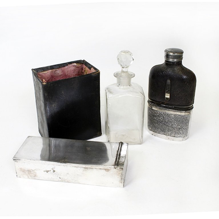 Leather, Glass and Sivler Plated Travel Set: Est. $ 30-45 Vintage Silverplated Set. 1) Henry Williams Limited Glass Flask with leather upper cover and silverplated base. Marked H.W.LD on the bottom 6" tall x 3" wide. Leather has break at base of