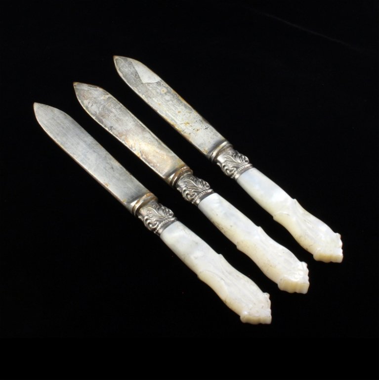 Set of Three Silver & Mop Carved Knives: Est $ 70-140 Set of three knvies with carved MOP handles and silver scroll work designed ferrules. The blades are discolored and are marked with an old english maker marks. The knives measure 5 3/4" l
