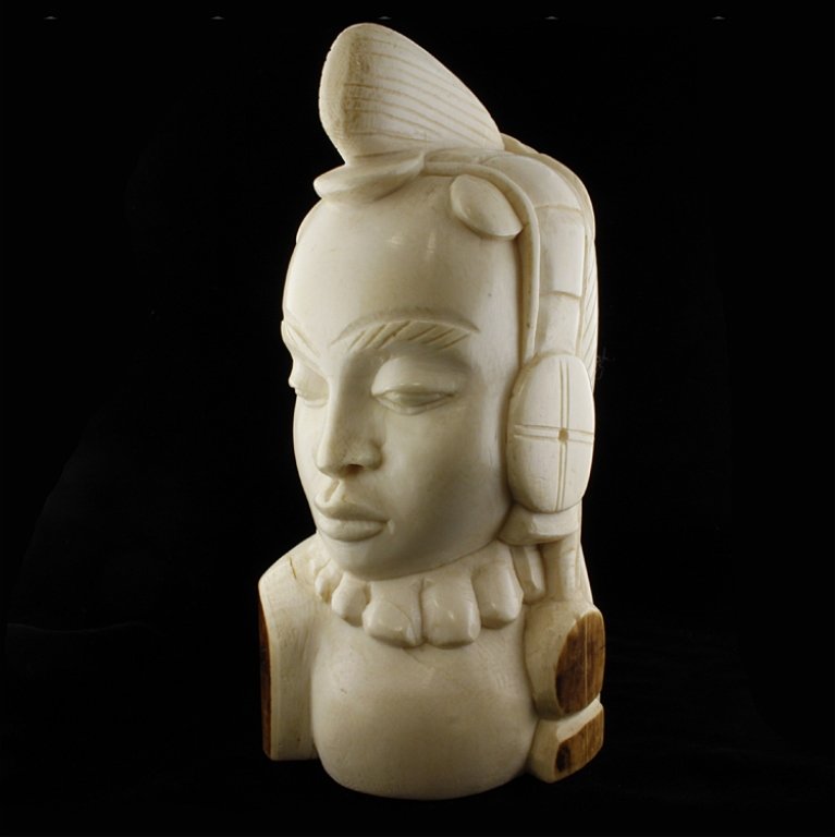 African Carved Ivory Bust of a Tribal Woman: Est $ 400-600 African hand carved ivory bust depicting a tribal woman.