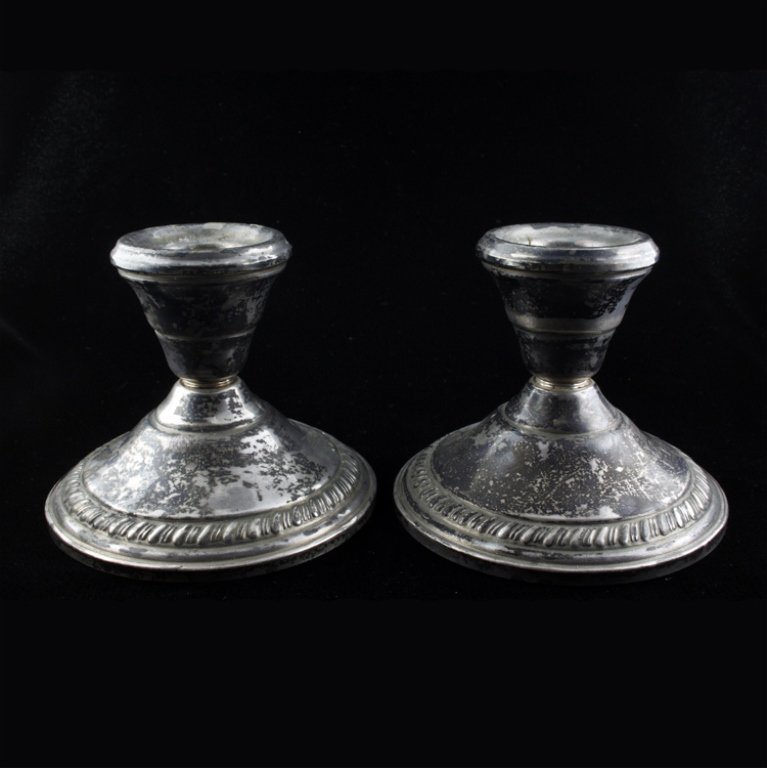Otto Reichardt Co. Sterling Candlestick Holders: Est $ 60-120 Set of two candlestick holders marked "Otto Reichardt Co. Sterling Reinforced with Cement" 2 1/2" tall x 3 1/8" in circumference at the base. Has minor discoloration.