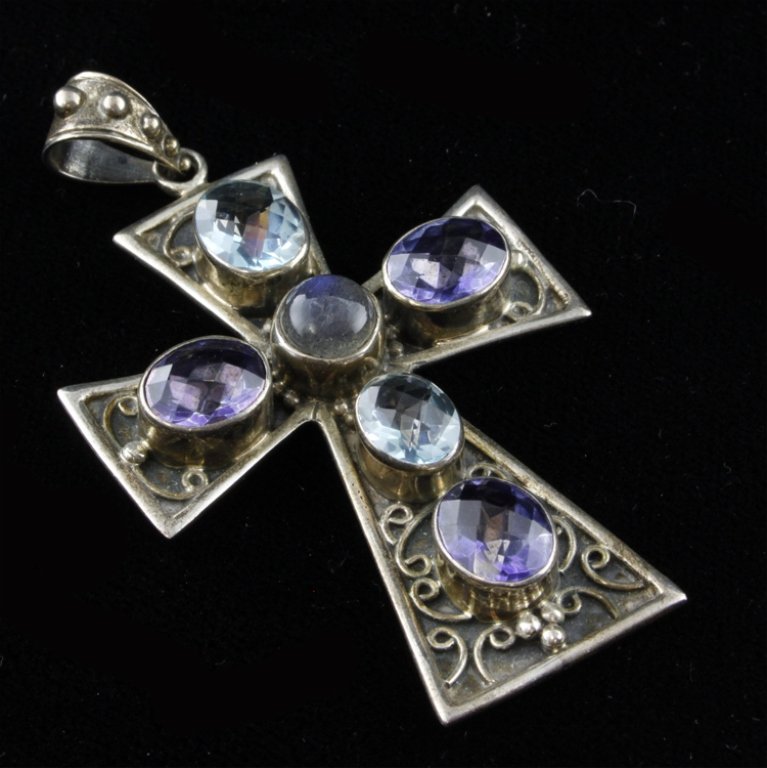 Nickey Butler Cross Sterling and Gemstone Pendant: Est. $ 30 - 60 Nickey Butler Cross Sterling and Gemstone Pendant 14.8 g tw. Measures 2.75" tall. Marked NB, 925.