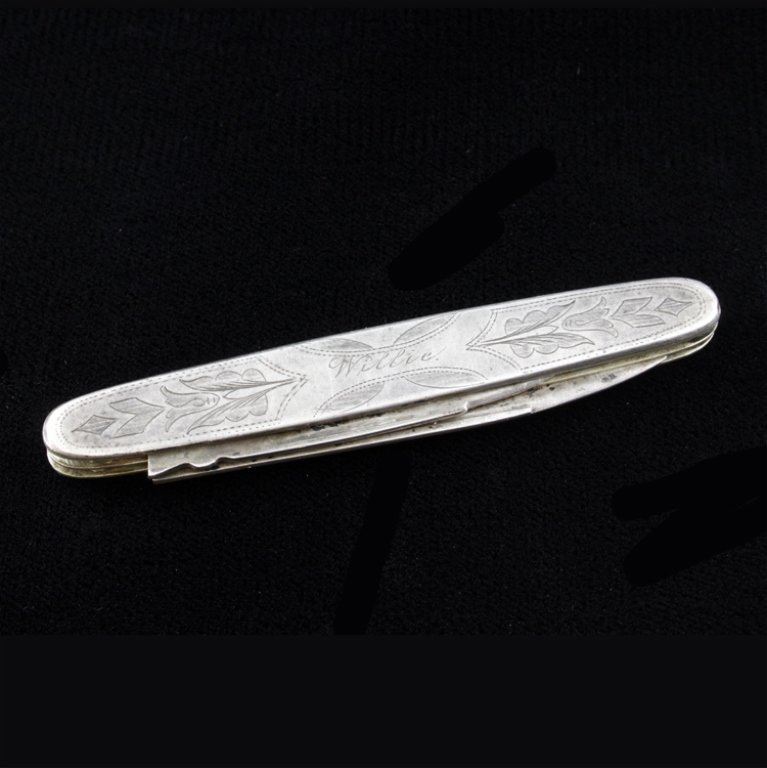 Coin Silver Etched Pocket Knife: Est $ 60-120 Pocket knife with an etched floral designed and engraved "Willie". One of the blades is marked coin and the knife measurse 3 1/8" long. 1.2 ozt.