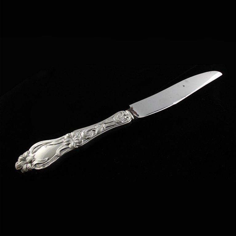 Sterling Handle Frank M. Whiting Co. Knife: Est $ 80-160 Knife with the 1910 Lily / Floral pattern. Marked Frank M. Whiting Co. and sterling on the handle and Stainless steel on the blade. 9 3/4" long.