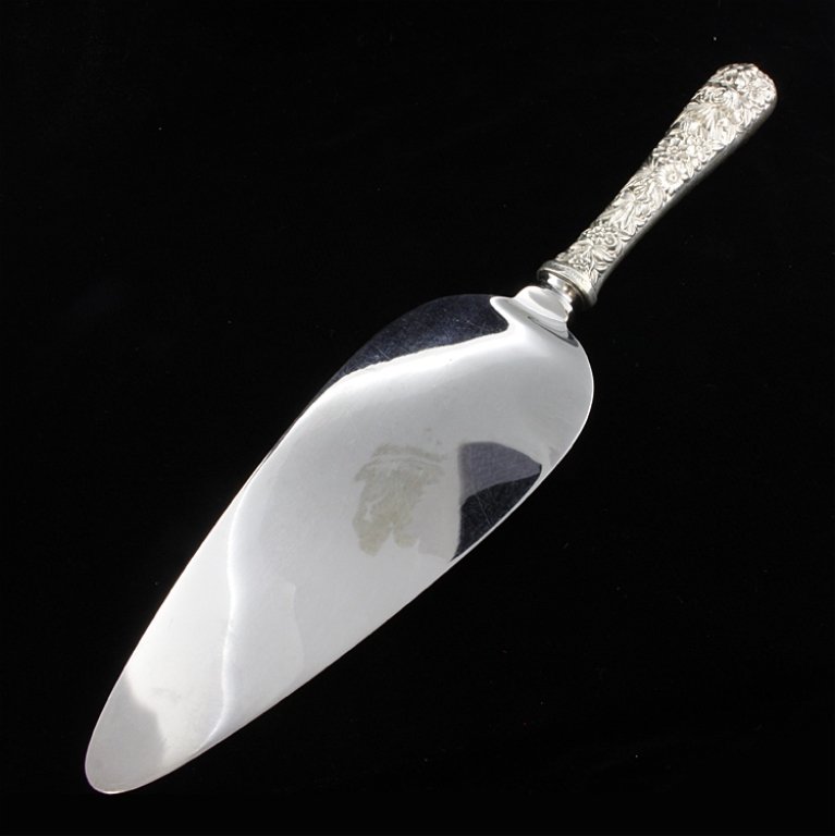 Sterling Handle S. Kirk & Son Pie Server: Est $ 100-200 Sterling handle pie server with a stainless blade in the Repousse sterling, 1924, S.Kirk & Son, Inc. pattern by S. Kirk & Sons. 10" long x 2 1/4" at the widest point and weighs 3.1 ozt.