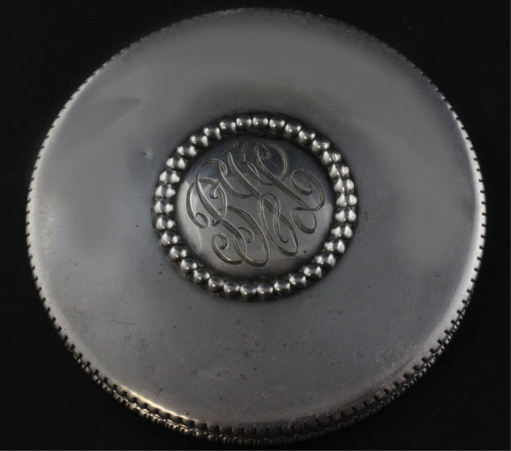 Edward San Giovanni Sterling Compact: Est. $ 100-150 Compact with mirror and hinged lid, monogrammed BJL inside a beaded circle. The lip of the lid is marked Edward San Giovanni and Sterling. The mirror has become unattached and has loose