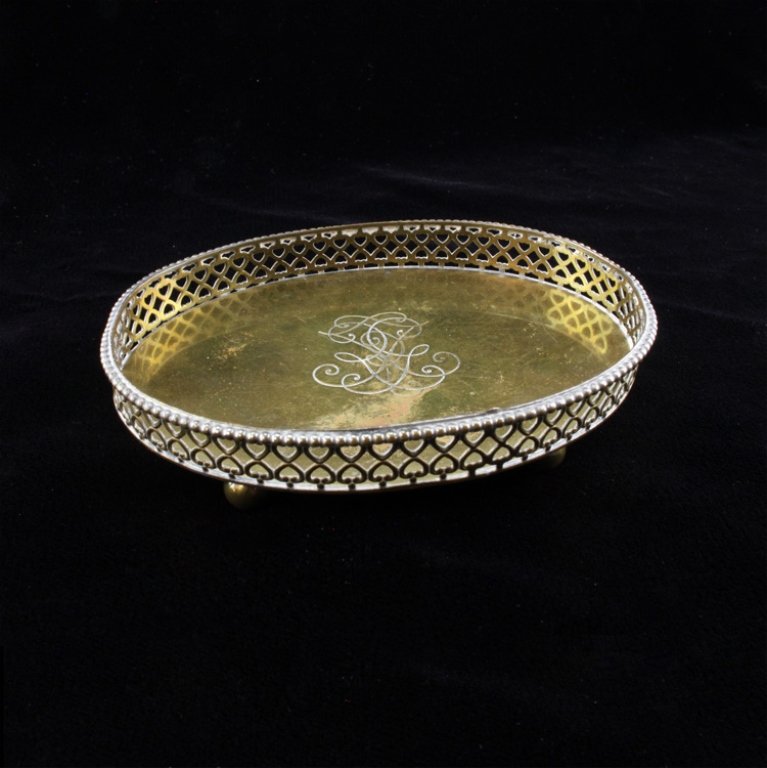 R. Miracoli Oval Vanity Tray: Est $ 60-100 Gold washed silver footed tray with a personalized monogram in the middle. The sides of the the tray are a pierced heart geometric design. Underneath the tray bears the Romeo Miracoli mak